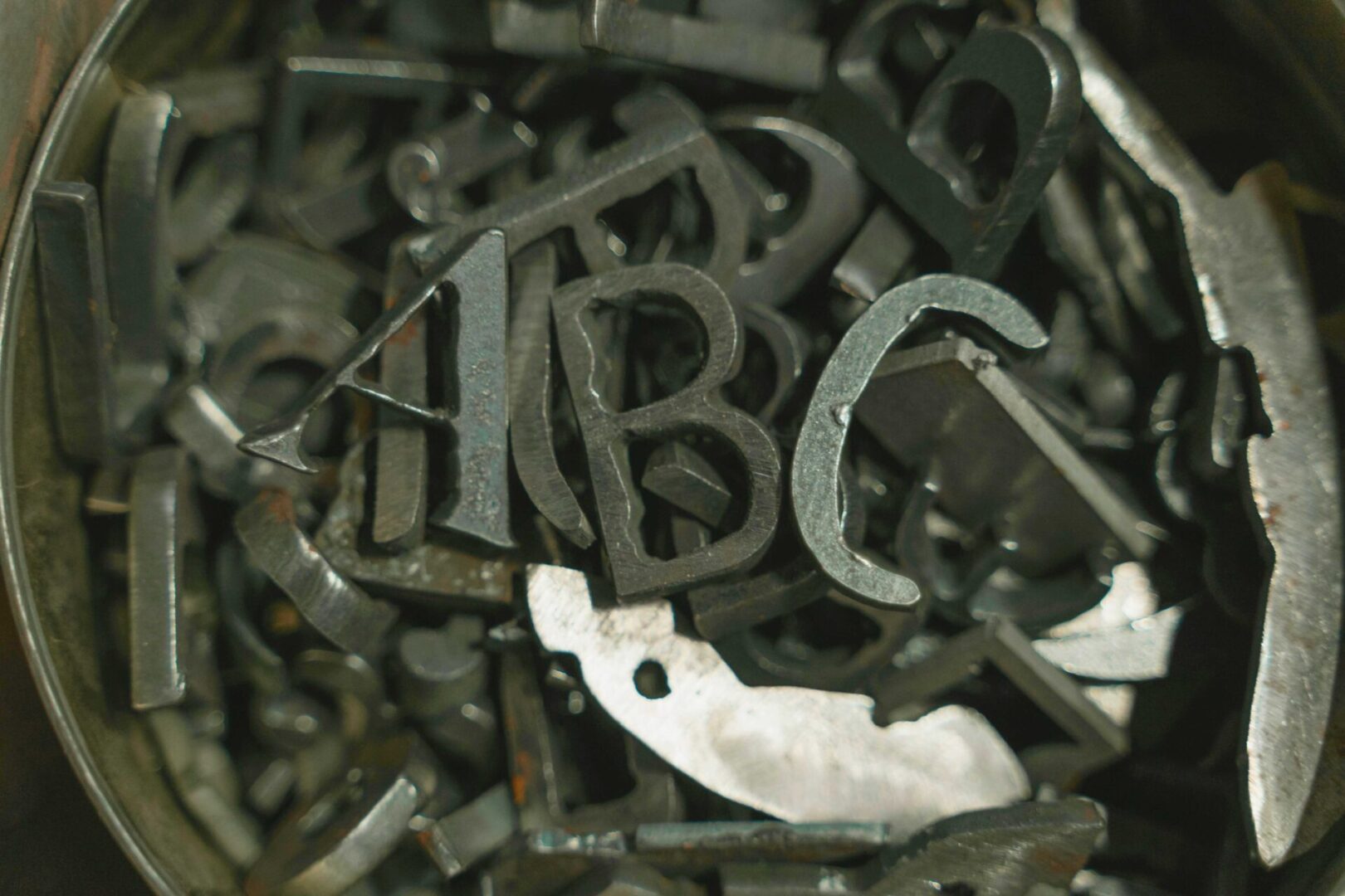 A pile of metal letters and numbers.