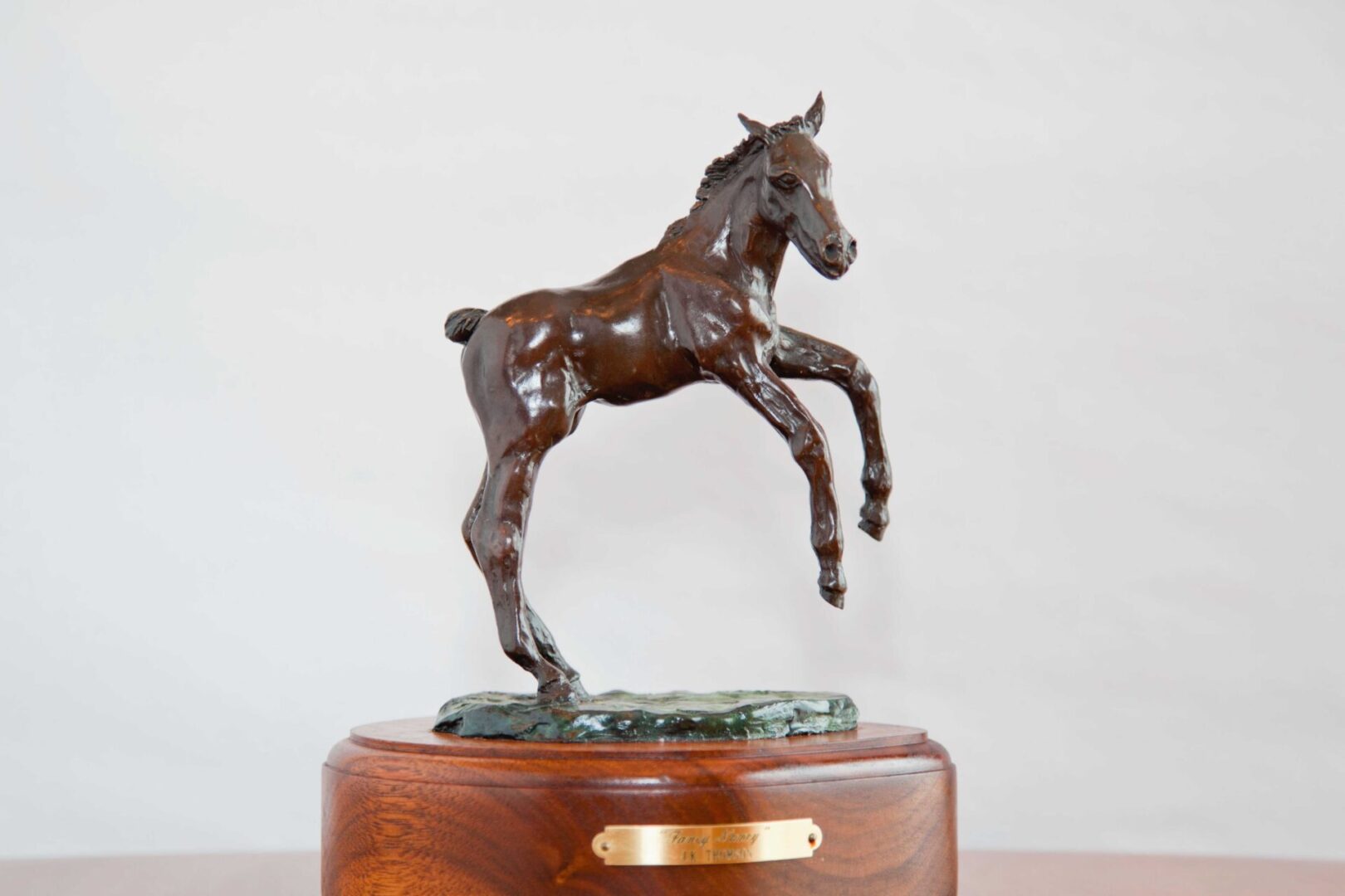 A horse statue on top of a wooden box.